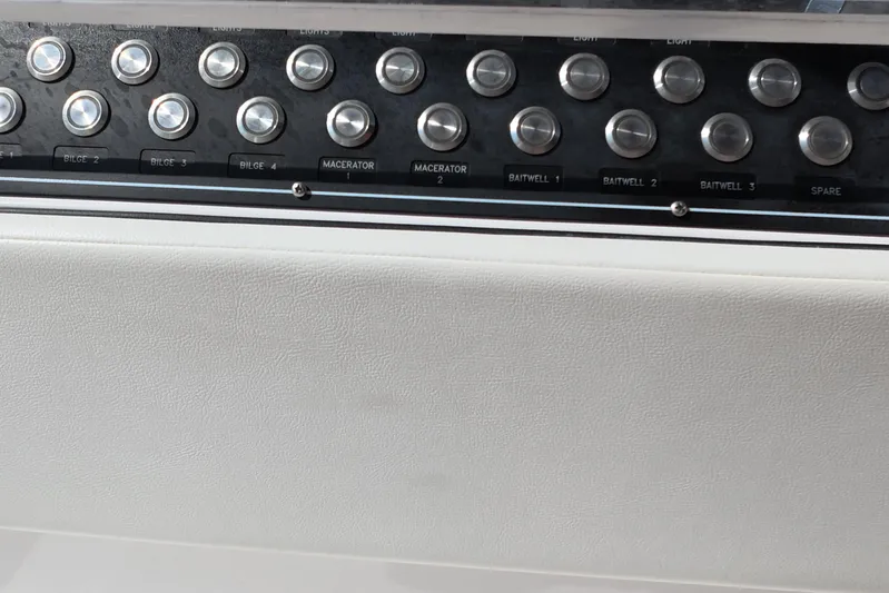  Yacht Photos Pics Control panel of 2023 Invincible 33 Catamaran with labeled buttons for bilge and baitwell.