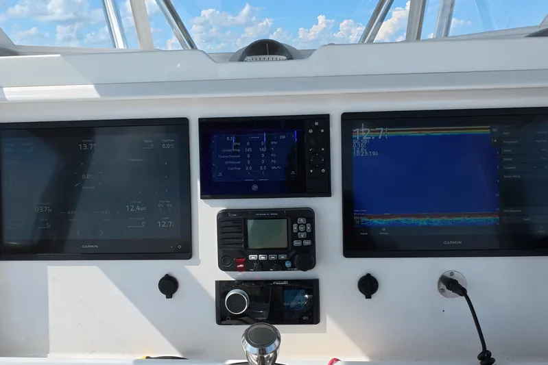  Yacht Photos Pics Dashboard of 2023 Invincible 33 Catamaran with Garmin navigation displays and controls.