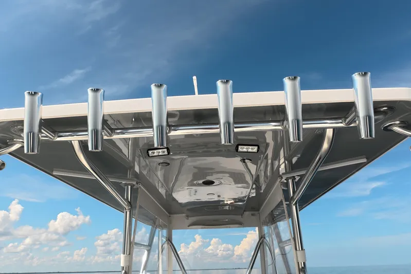  Yacht Photos Pics 2023 Invincible 33 Catamaran T-top with rod holders against blue sky.