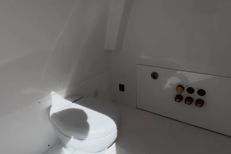  Yacht Photos Pics Interior of 2023 Invincible 33 Catamaran featuring a compact marine toilet.