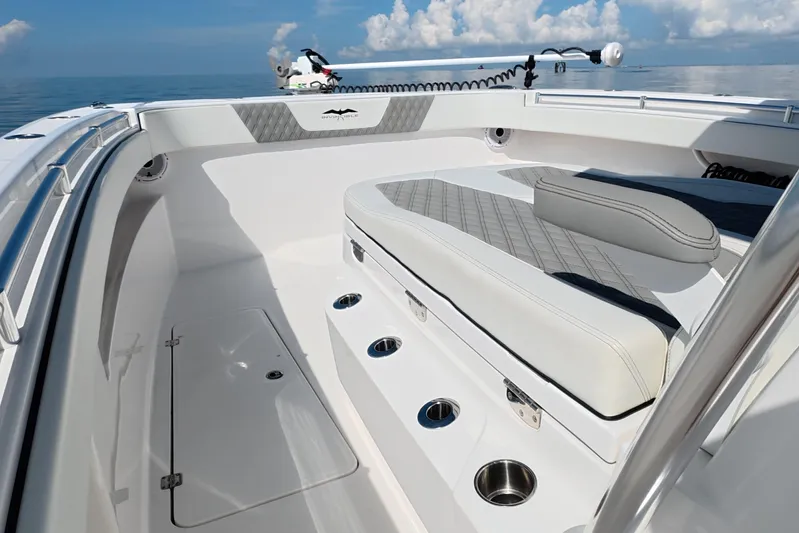  Yacht Photos Pics 2023 Invincible 33 Catamaran interior with cushioned seating and stainless steel cup holders.