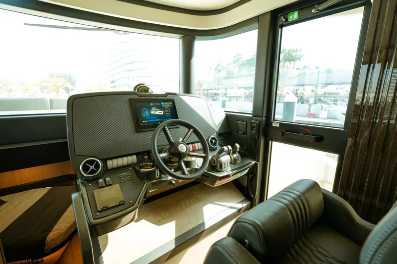  Yacht Photos Pics Helm of 2024 Absolute NAVETTA 52 yacht, featuring modern controls and luxurious seating.