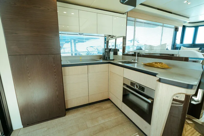  Yacht Photos Pics Modern kitchen interior of 2024 Absolute NAVETTA 52 yacht, featuring sleek cabinetry and appliances.