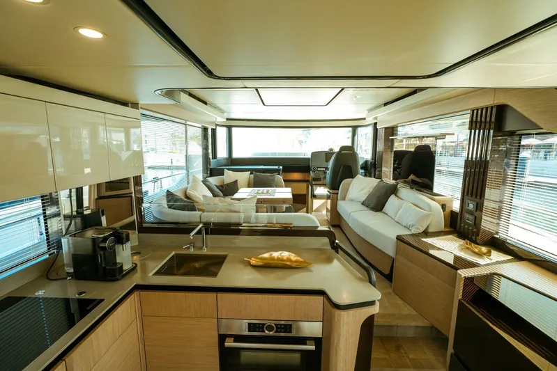  Yacht Photos Pics Luxurious interior of 2024 Absolute NAVETTA 52 yacht with modern kitchen and seating area.
