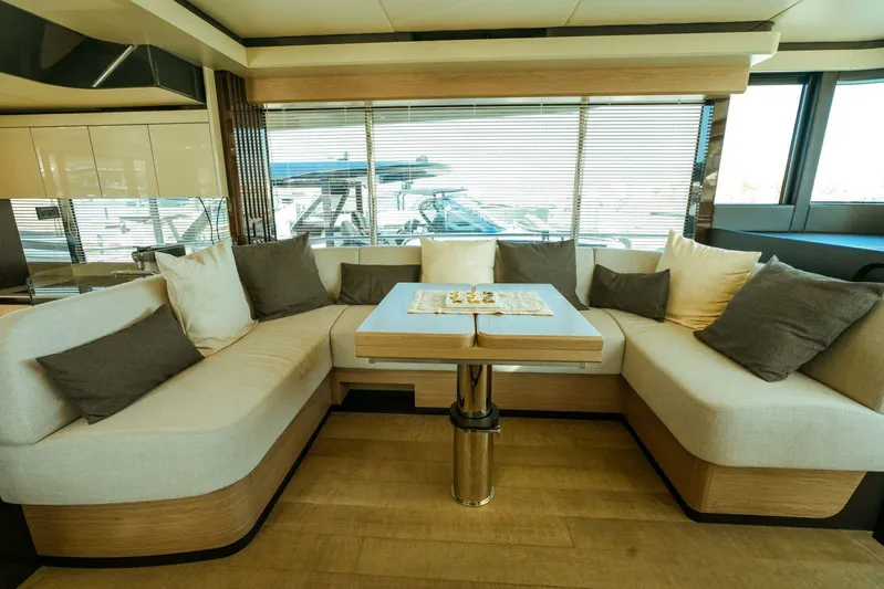  Yacht Photos Pics Luxurious interior of 2024 Absolute NAVETTA 52 yacht with elegant seating and table.