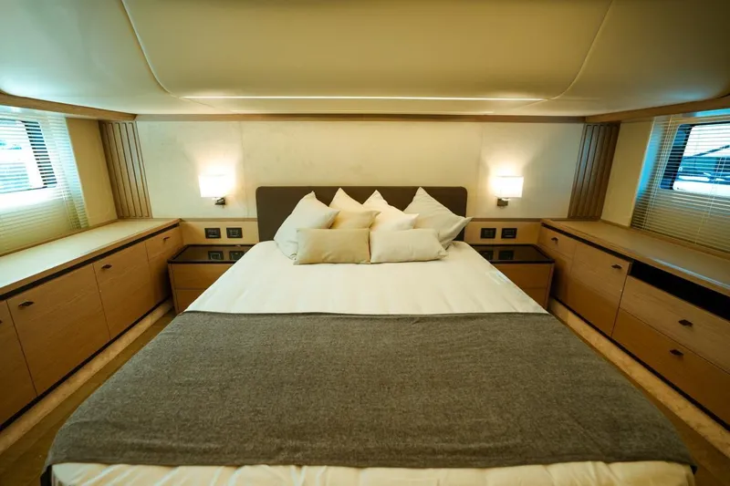  Yacht Photos Pics Luxurious bedroom interior of 2024 Absolute NAVETTA 52 yacht with modern design and cozy ambiance.