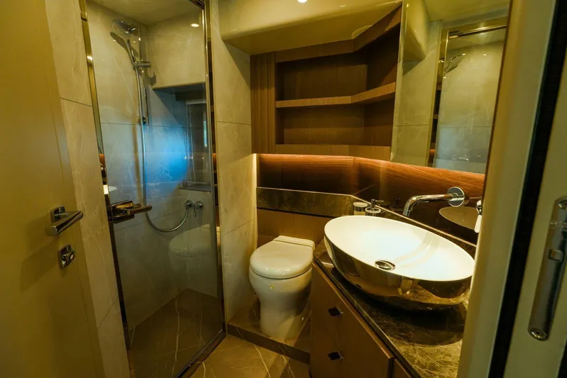  Yacht Photos Pics Luxurious bathroom in 2024 Absolute NAVETTA 52 yacht with modern fixtures and elegant design.