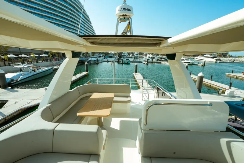  Yacht Photos Pics Luxurious 2024 Absolute NAVETTA 52 yacht with spacious deck and marina view.