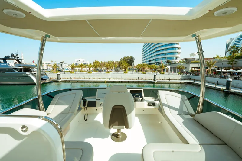  Yacht Photos Pics 2024 Absolute NAVETTA 52 yacht interior with marina view, featuring modern seating and helm.