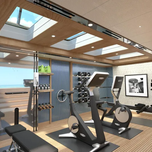 Spitfire Yacht Photos Pics Luxurious yacht gym with modern equipment, skylights, and ocean view, 2027 ARES SPITFIRE.