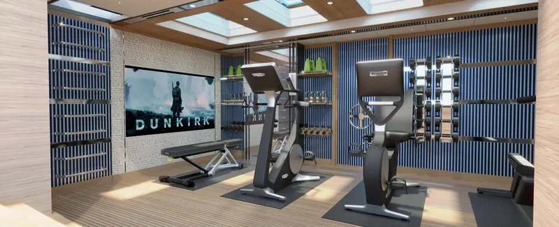 Spitfire Yacht Photos Pics Luxurious home gym with modern equipment, featuring a large screen displaying "Dunkirk."