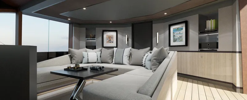 Spitfire Yacht Photos Pics Luxurious yacht interior with modern design, featuring a spacious gray sectional sofa and elegant decor.