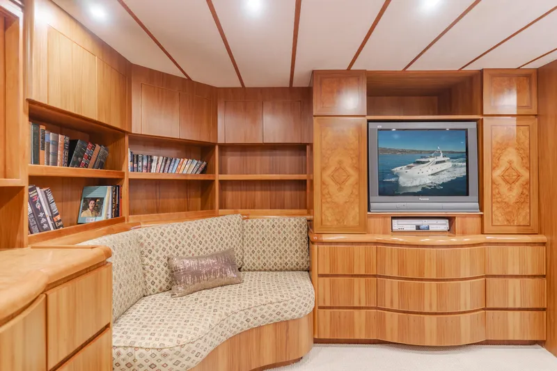 Money Cat Yacht Photos Pics Luxurious 2003 TransWorld CUSTOM yacht interior with wood paneling, built-in shelves, and cozy seating.