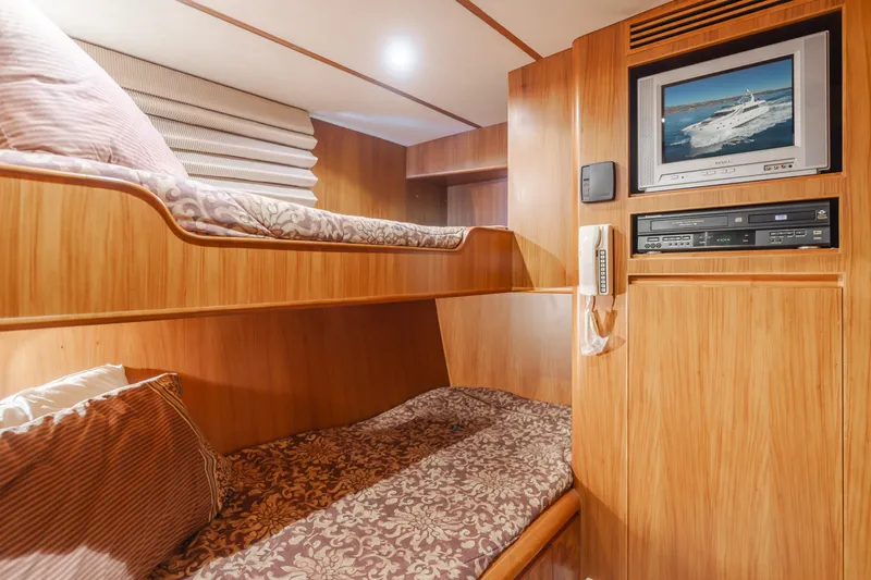 Money Cat Yacht Photos Pics 2003 TransWorld CUSTOM yacht cabin with bunk beds, TV, and wooden interior.
