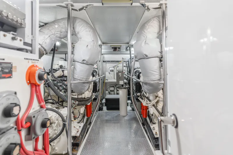 Money Cat Yacht Photos Pics Engine room of a 2003 TransWorld CUSTOM boat with dual engines and insulated exhausts.