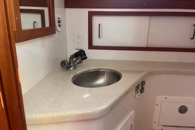  Yacht Photos Pics 2008 Back Cove 29 boat interior with sink and storage cabinets.