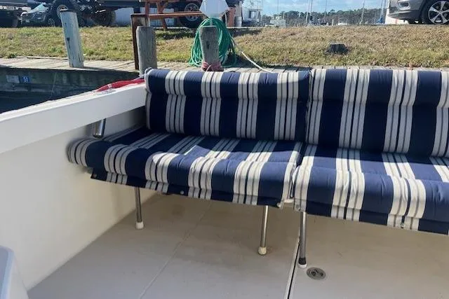  Yacht Photos Pics 2008 Back Cove 29 boat with striped seating at a dock.