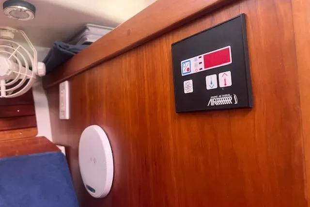  Yacht Photos Pics 2008 Back Cove 29 interior with control panel and fan on wooden wall.