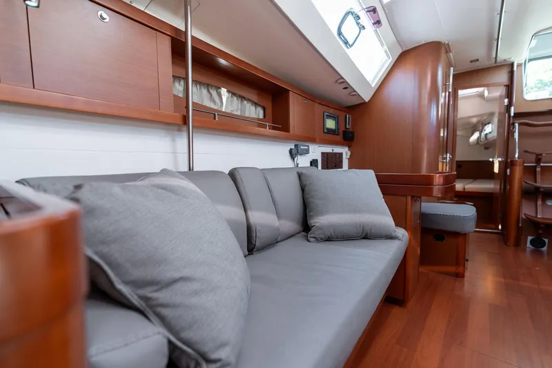 Resiliance Yacht Photos Pics Interior of 2013 Beneteau Oceanis 50 yacht with modern wood finish and gray seating.