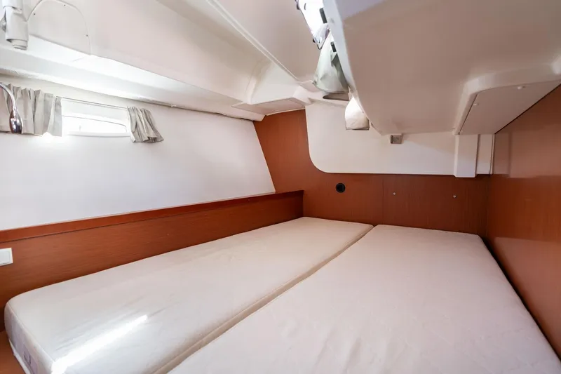 Resiliance Yacht Photos Pics 2013 Beneteau Oceanis 50 cabin interior with twin beds and wooden paneling.