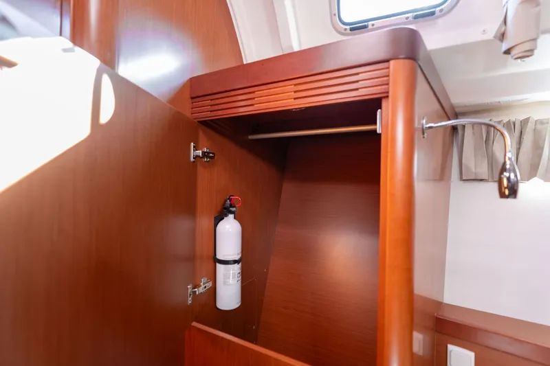 Resiliance Yacht Photos Pics 2013 Beneteau Oceanis 50 interior closet with fire extinguisher and wooden finish.