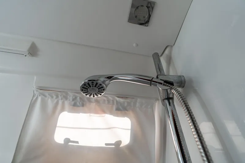 Resiliance Yacht Photos Pics Shower area in 2013 Beneteau Oceanis 50 yacht, featuring chrome fixtures and a window.