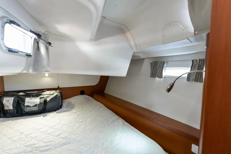 Resiliance Yacht Photos Pics Cozy cabin interior of 2013 Beneteau Oceanis 50 sailboat with bed and porthole.