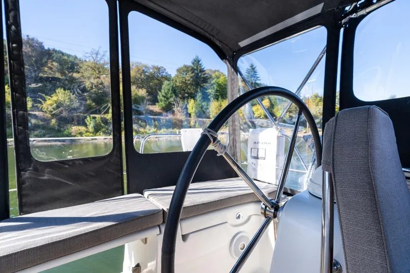 Resiliance Yacht Photos Pics Cockpit view of 2013 Beneteau Oceanis 50 sailboat with steering wheel and seating.
