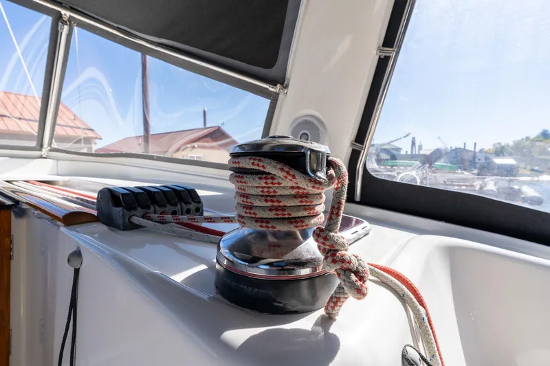 Resiliance Yacht Photos Pics Winch and ropes on 2013 Beneteau Oceanis 50 sailboat deck, sunny day.