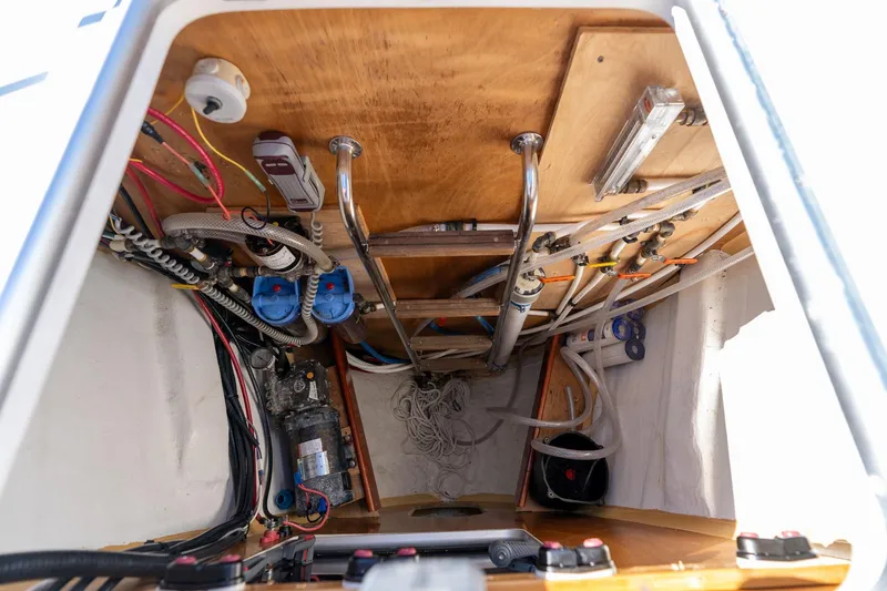 Resiliance Yacht Photos Pics Engine compartment of 2013 Beneteau Oceanis 50 sailboat, showcasing wiring and mechanical components.
