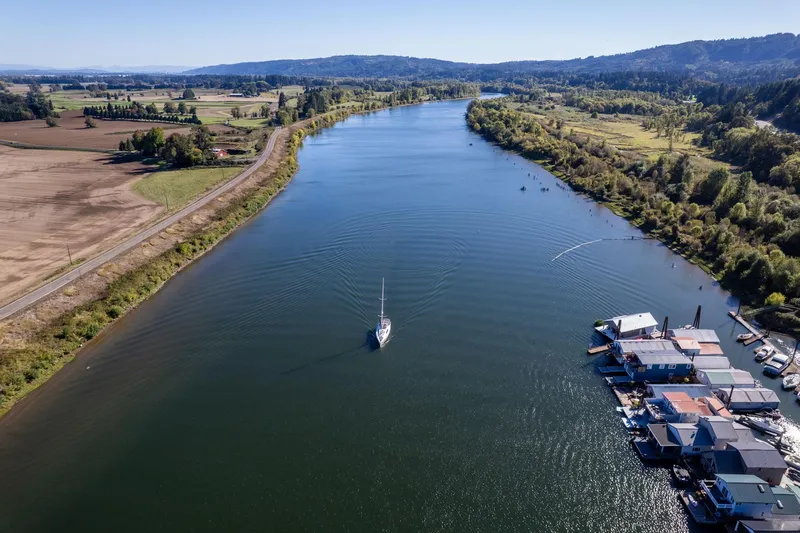 Resiliance Yacht Photos Pics Aerial view of 2013 Beneteau Oceanis 50 sailing on a scenic river.
