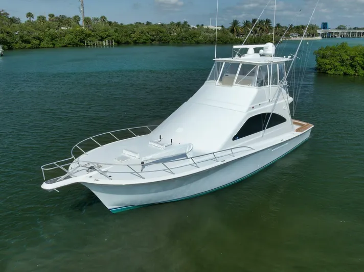 Mullet Yacht Photos Pics 2006 Ocean Yachts 50 Super Sport boat on calm water, surrounded by lush greenery.