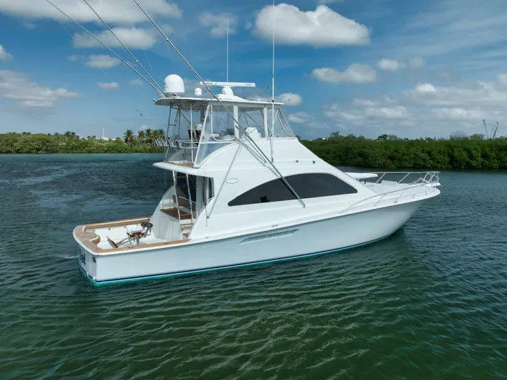 Mullet Yacht Photos Pics 2006 Ocean Yachts 50 Super Sport boat on calm water under blue sky.