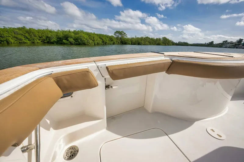 Mullet Yacht Photos Pics 2006 Ocean Yachts 50 Super Sport boat deck with cushioned seating, overlooking serene water and greenery.