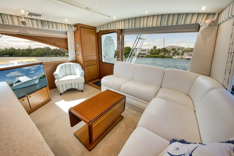 Mullet Yacht Photos Pics Luxurious interior of 2006 Ocean Yachts 50 Super Sport with white seating and scenic window view.