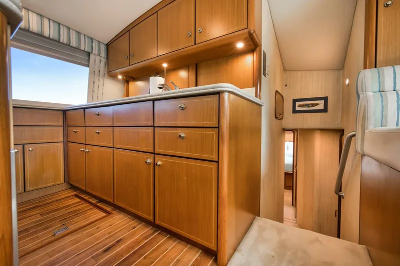Mullet Yacht Photos Pics Interior of 2006 Ocean Yachts 50 Super Sport with wooden cabinetry and flooring.