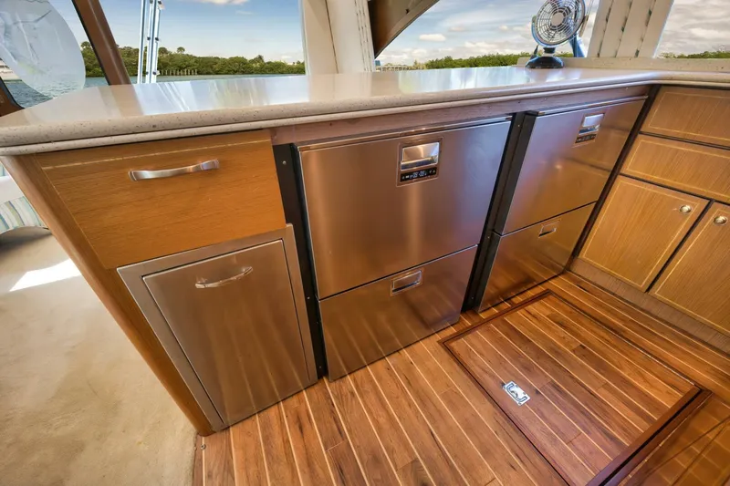 Mullet Yacht Photos Pics Luxurious 2006 Ocean Yachts 50 Super Sport galley with stainless steel appliances and wood flooring.