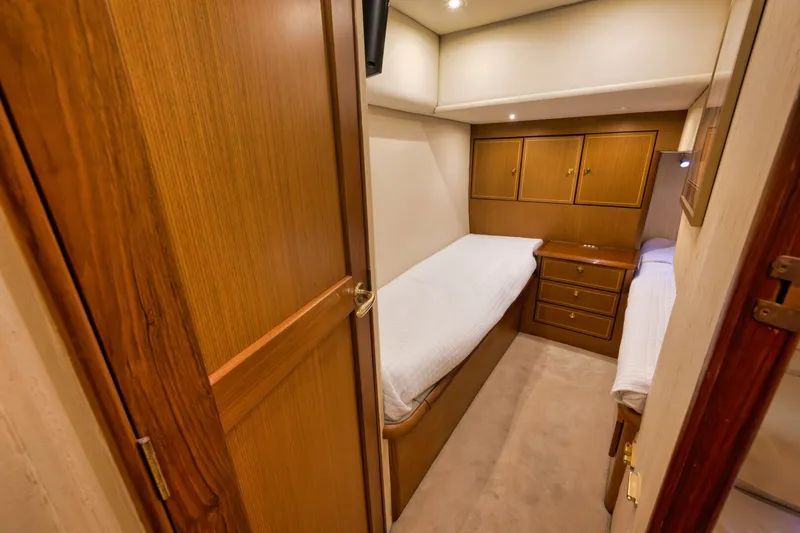 Mullet Yacht Photos Pics 2006 Ocean Yachts 50 Super Sport cabin with twin beds and wooden cabinetry.
