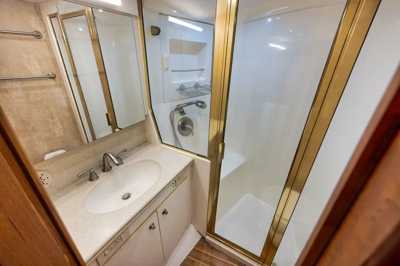 Mullet Yacht Photos Pics Luxurious bathroom in 2006 Ocean Yachts 50 Super Sport with glass shower and elegant fixtures.