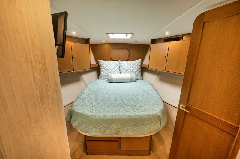 Mullet Yacht Photos Pics Luxurious cabin interior of 2006 Ocean Yachts 50 Super Sport with cozy bed and wooden cabinets.