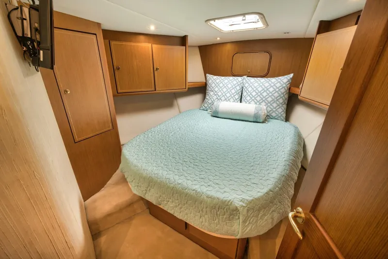 Mullet Yacht Photos Pics Luxurious cabin interior of 2006 Ocean Yachts 50 Super Sport with cozy bedding.