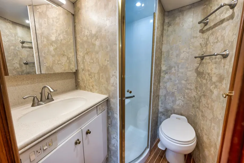 Mullet Yacht Photos Pics Luxurious bathroom in 2006 Ocean Yachts 50 Super Sport with shower, sink, and toilet.