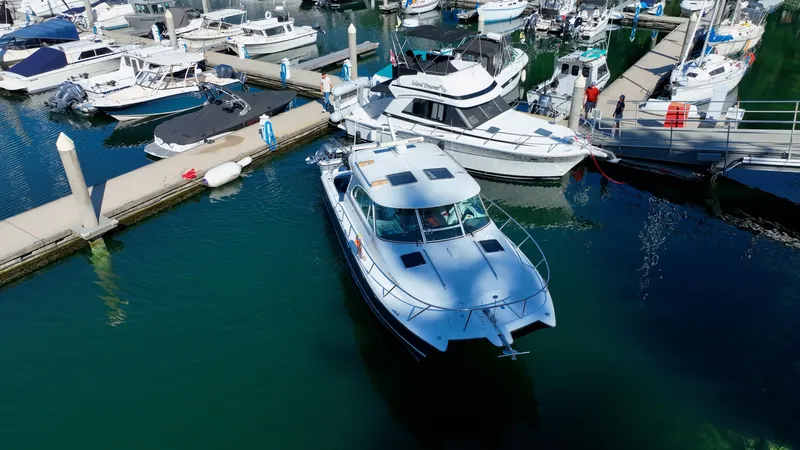  Yacht Photos Pics 2007 Glacier Bay 3480 Ocean Runner docked at a marina with other boats.