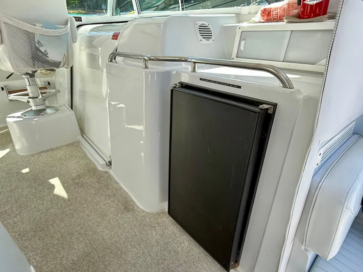  Yacht Photos Pics 2007 Glacier Bay 3480 Ocean Runner interior with seating and compact fridge.