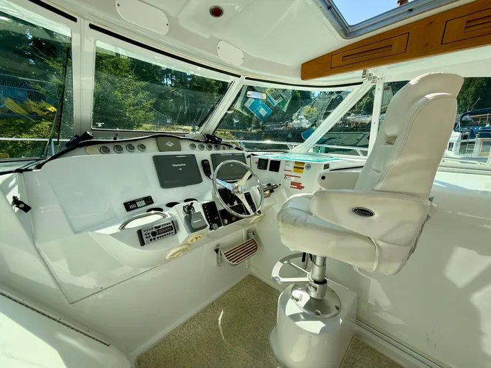  Yacht Photos Pics Helm of 2007 Glacier Bay 3480 Ocean Runner with white captain's chair and navigation equipment.