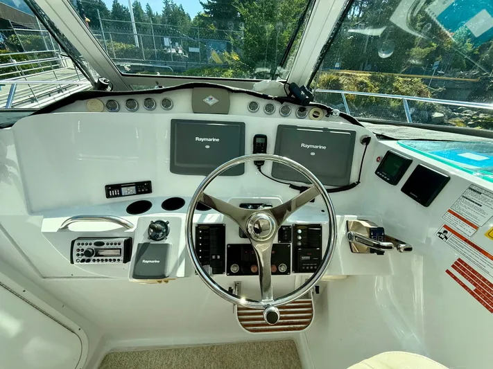  Yacht Photos Pics 2007 Glacier Bay 3480 Ocean Runner helm with Raymarine electronics and steering wheel.