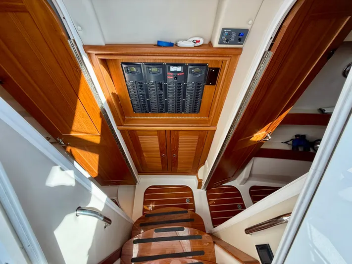  Yacht Photos Pics Interior of 2007 Glacier Bay 3480 Ocean Runner with wooden cabinetry and control panel.