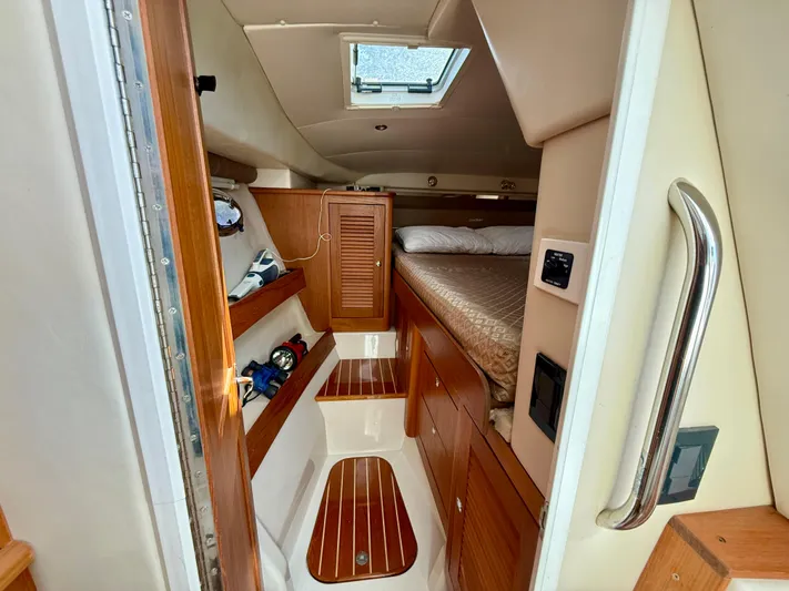  Yacht Photos Pics 2007 Glacier Bay 3480 Ocean Runner cabin interior with wood accents and cozy sleeping area.