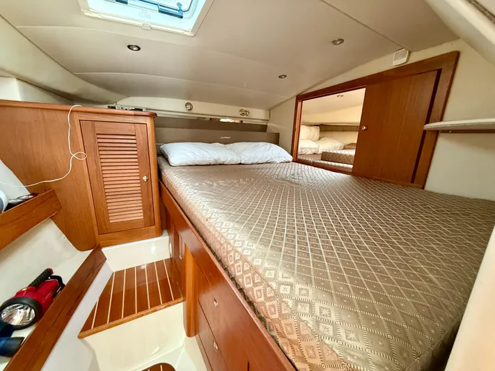  Yacht Photos Pics Luxurious cabin interior of 2007 Glacier Bay 3480 Ocean Runner with wood accents and cozy bedding.