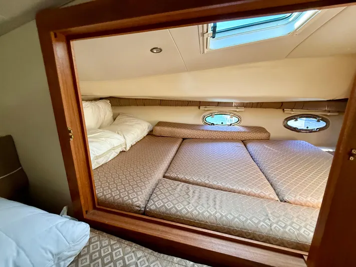  Yacht Photos Pics Interior cabin of 2007 Glacier Bay 3480 Ocean Runner with cozy bedding and porthole windows.